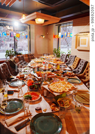 large table served in the pizzeria. the Italian cuisine. 99692097