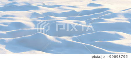 Natural winter background with snow drifts and falling snow 99693796