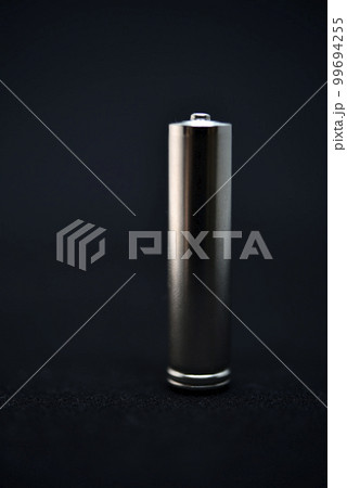 A shiny electric battery on a black background. The battery is a close-up. A shiny electric battery on a black background. The battery is a close-up. 99694255