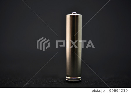 A shiny electric battery on a black background. The battery is a close-up. A shiny electric battery on a black background. The battery is a close-up. 99694259