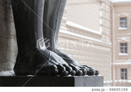 Feet of black granite Atlas statue. Classic architecture Feet of black granite Atlas statue. Classic architecture 99695199