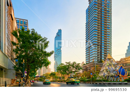 Street in Bangkok, Thailand, high-rises, trees, sunlight, evening. Street in Bangkok, Thailand, high-rises, trees, sunlight, evening. 99695530