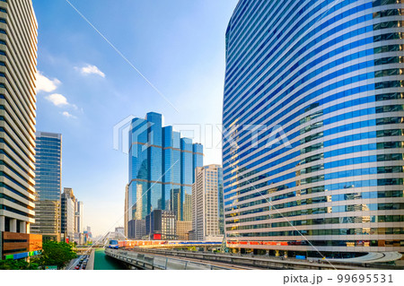 Metro car arrive in business downtown of modern city of skyscrapers.  99695531