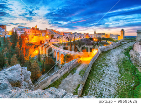Fabulous view on Gravina in Puglia ancient town, bridge and canyon at sunris Fabulous view on Gravina in Puglia ancient town, bridge and canyon at sunris 99695628