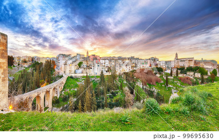 Breathtaking view on Gravina in Puglia ancient town, bridge and canyon at sunris Breathtaking view on Gravina in Puglia ancient town, bridge and canyon at sunris 99695630