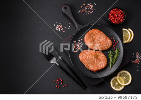 Two baked slices of tuna fillet with spices and herbs 99697175