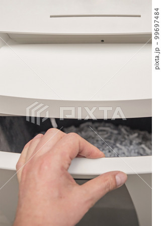 Industrial paper shredder. Paper shredder in the office, use and maintenance of professional office equipment. 99697484