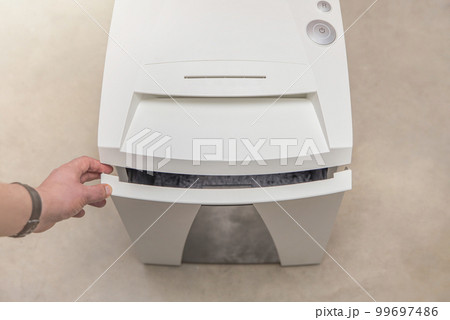 Industrial paper shredder. Paper shredder in the office, use and maintenance of professional office equipment. 99697486