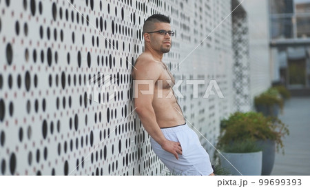 Muscular young man Arab posing against white background. 99699393