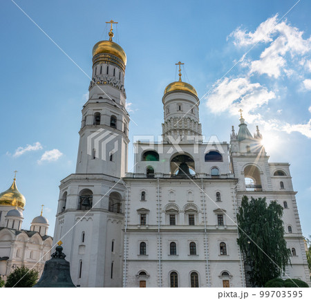 Ivan the Great Bell Tower, with Assumption Belfry on the right in Moscow Kremlin. Blue sky background with sunbeams 99703595