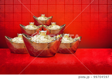 old six gold chinese money stack on red velvet fabric floor, red wall background, decor,  99704597