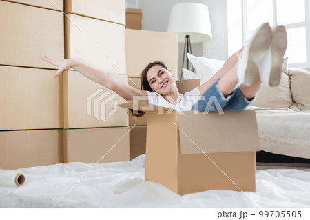 happy young woman unpacking boxes in new apartment 99705505