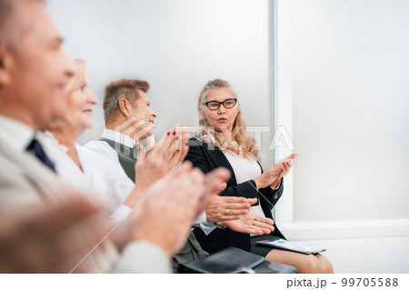 close up. a group of business people applaud during a business seminar. close up. a group of business people applaud during a business seminar. 99705588