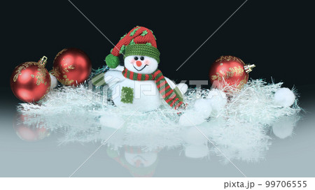 Toy snowman with festive red balls. black background 99706555