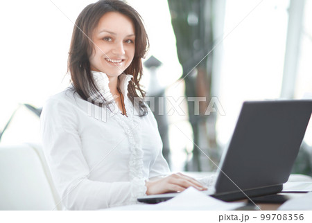 closeup. modern business woman working with documents sitting at her Desk closeup. modern business woman working with documents sitting at her Desk 99708356
