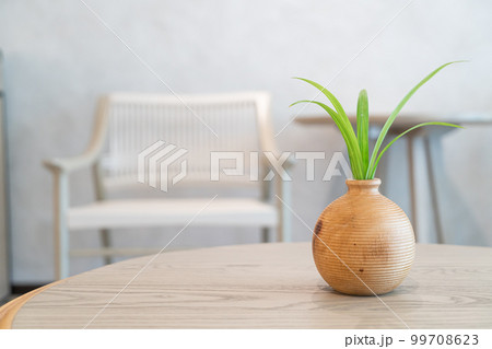ceramic or porcelain vase with plant decoration on table in living room ceramic or porcelain vase with plant decoration on table in living room 99708623