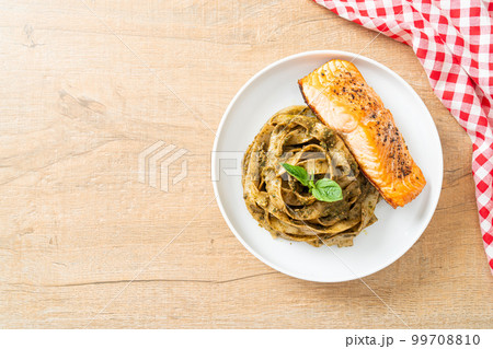 pesto fettuccine spaghetti pasta with grilled salmon fillet 99708810