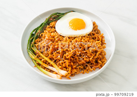 dried Korean spicy instant noodles with fried egg 99709219