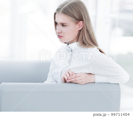 thoughtful young business woman sitting in the lobby of the office 99711404