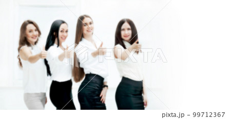 blurred image for the advertising text. photo with copy space. triumphant business team holding thumbs up. 99712367