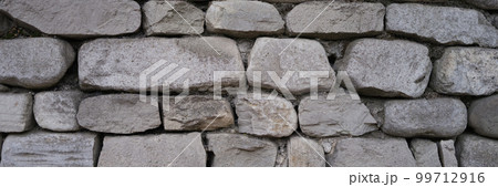 Stone old wall fencing seamless texture closeup 99712916
