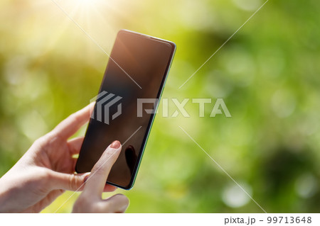 Closeup view of the woman's hands holding smartphone. 99713648