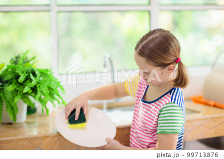 Child washing dishes. Child washing dishes. 99713876