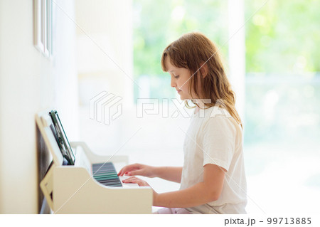 Child playing piano. Kids play music. Child playing piano. Kids play music. 99713885