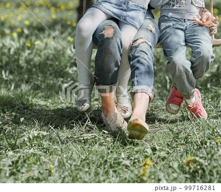 mom and her two little daughters spend their free time together 99716281