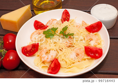 Pasta bows with tomatoes and parmesan cheese 99716443