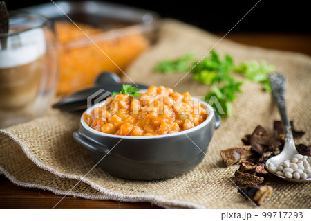 beans stewed with vegetables and spices, in a bowl . 99717293