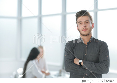 young business man standing in his office 99718487