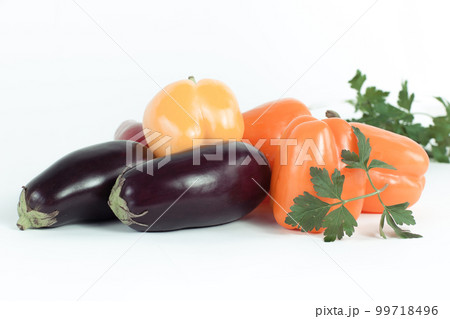 bell pepper,eggplants and sprigs of parsley on a white background. bell pepper,eggplants and sprigs of parsley on a white background. 99718496