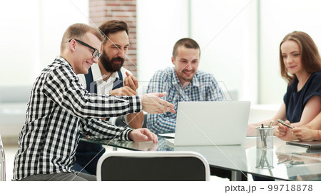 business team looking at the laptop screen and discussing their ideas business team looking at the laptop screen and discussing their ideas 99718878