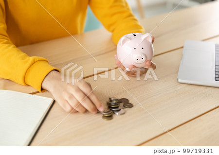 Saving money investment for future. Female woman hands holding pink piggy bank and putting money coin. Saving investment budget business wealth retirement financial money banking concept Saving money investment for future. Female woman hands holding pink piggy bank and putting money coin. Saving investment budget business wealth retirement financial money banking concept 99719331