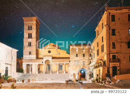 Terracina, Italy. Tower Of Cathedral Of San Cesareo In Night Time. It Built On Podium Of Temple Of Roma And Augustus. Bright Blue Night Sky. Amazing Scenic View Night Starry Sky Background 99720122