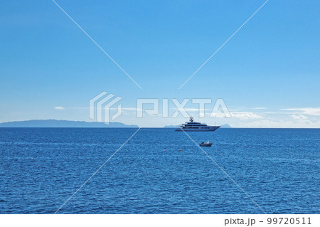A modern boat in the ocean or the sea against the backdrop of islands. A modern boat in the ocean or the sea against the backdrop of islands. 99720511