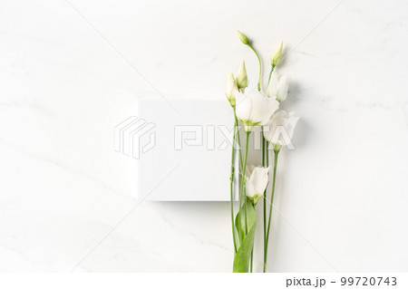 Summer minimal scene for beauty cosmetic product presentation made with white cube and Lysianthus flower on white background. 99720743