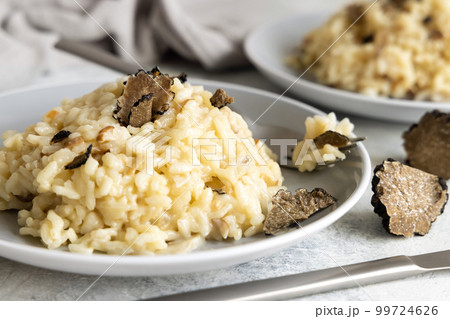 Risotto with porcini mushrooms and black truffles served in a plate top view, gourmet cousine Risotto with porcini mushrooms and black truffles served in a plate top view, gourmet cousine 99724626