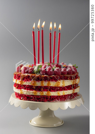 birthday cake on a stand with candles 99725360