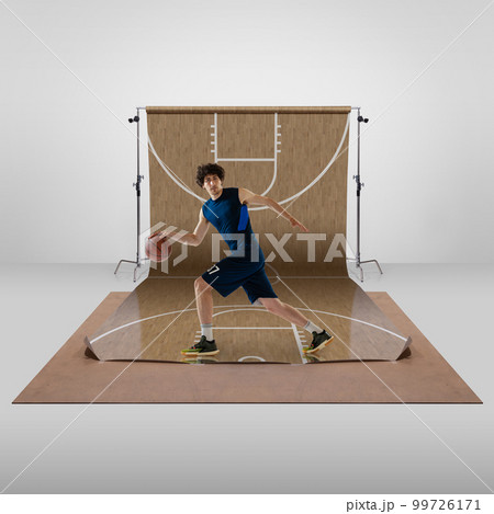 Dribbling. Young sportive man, professional basketball player in motion, training over sports playground background. Concept of sport 99726171