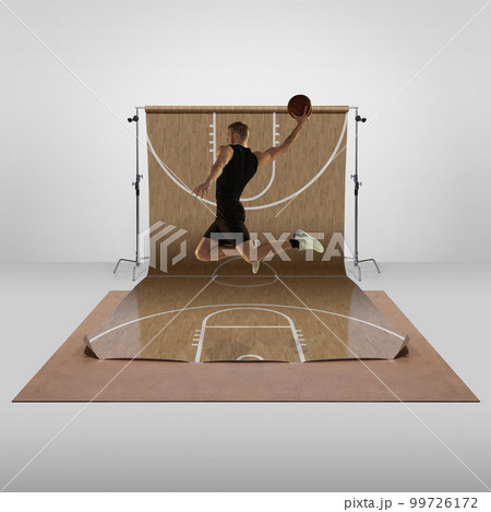 Young sportive man, professional basketball player in motion, playing, training over sports playground background. Concept of sport 99726172