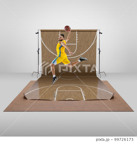 Man, professional basketball player in motion, training over sports playground background. Concept of sport 99726173