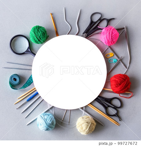 Knitting accessories, knitting hook, knitting needles, scissors, magnifying glass, needles, centimeter and balls of thread with space for text. Flat lay Knitting accessories, knitting hook, knitting needles, scissors, magnifying glass, needles, centimeter and balls of thread with space for text. Flat lay 99727672