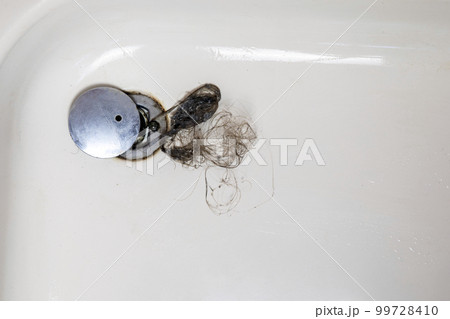 Shower drain is clogged with hair, Hair pile loss in a bathroom after wash hair in shower, cleaning bathroom and removing hair top view Shower drain is clogged with hair, Hair pile loss in a bathroom after wash hair in shower, cleaning bathroom and removing hair top view 99728410