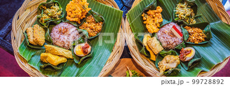 Nasi lemak, Nasi campur, Indonesian Balinese rice with potato fritter, sate lilit, fried tofu, spicy boiled eggs, and peanut BANNER, LONG FORMAT 99728892