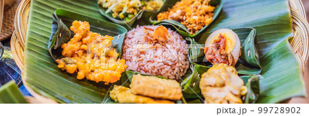 Nasi lemak, Nasi campur, Indonesian Balinese rice with potato fritter, sate lilit, fried tofu, spicy boiled eggs, and peanut BANNER, LONG FORMAT 99728902
