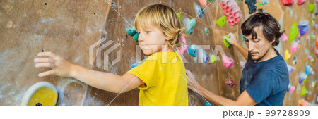 Dad and son at the climbing wall. Family sport, healthy lifestyle, happy family BANNER, LONG FORMAT 99728909