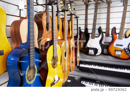 Various acoustic six-string guitars in a music store Various acoustic six-string guitars in a music store 99729362