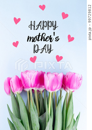 Beautiful pink white tulips in a row on blue background, horizontal, copy space, top view 99729812